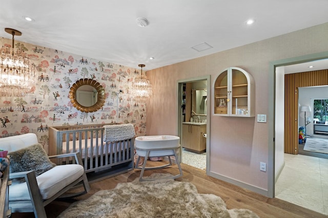 1510 Sarria Ave, Coral Gables, FL 33146 - bedroom featuring a chandelier, wallpapered walls, recessed lighting, baseboards, and wood finished floors