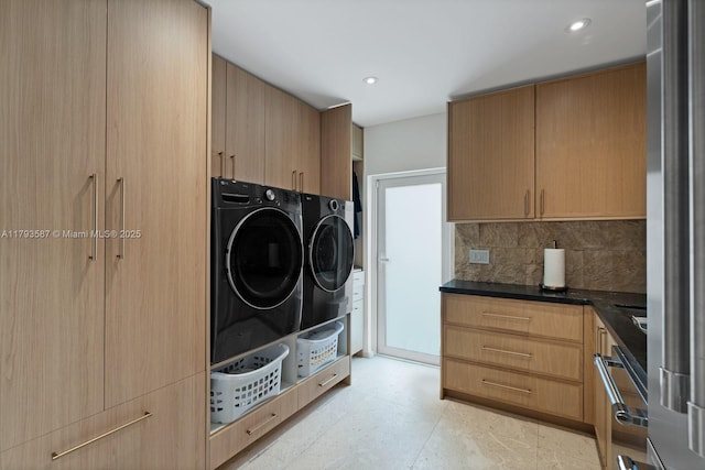 laundry area featuring recessed lighting, cabinet space, and washer and dryer