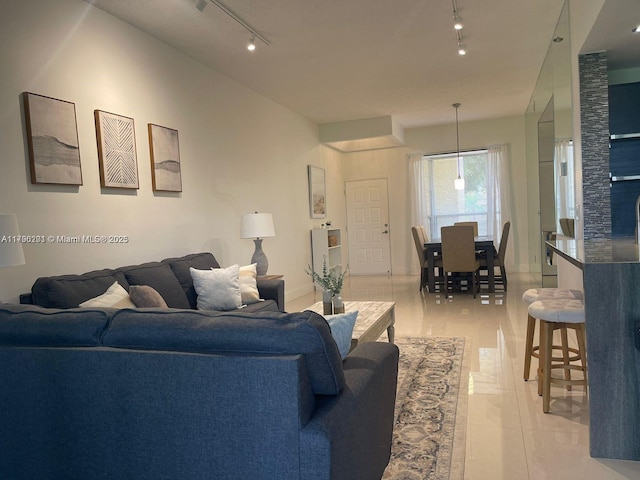 living room featuring rail lighting and light tile patterned floors