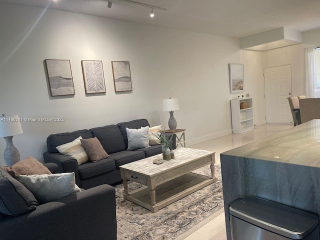 living room with light tile patterned floors and track lighting