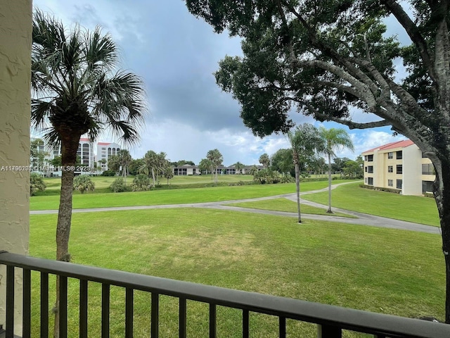 surrounding community featuring fence and a lawn