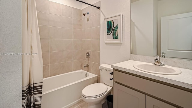 full bath featuring vanity, toilet, a textured wall, and shower / bathtub combination with curtain