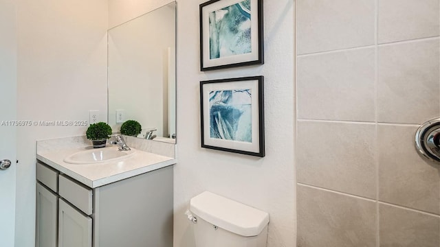 bathroom with toilet and vanity