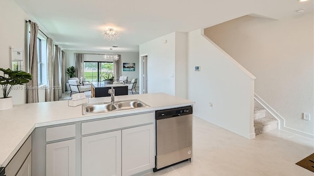 kitchen featuring a notable chandelier, light countertops, a sink, and stainless steel dishwasher