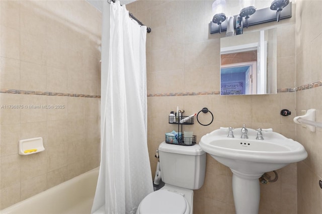 full bath featuring tile walls, toilet, and shower / tub combo with curtain