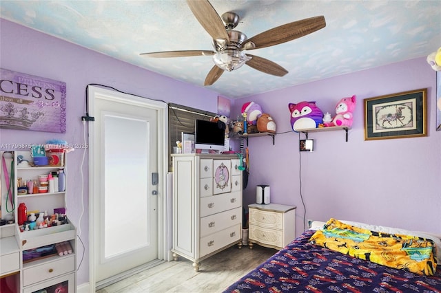 bedroom with a ceiling fan and wood finished floors