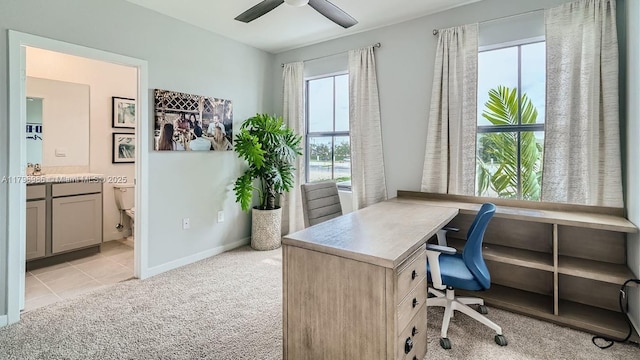 office area with light colored carpet, baseboards, and ceiling fan