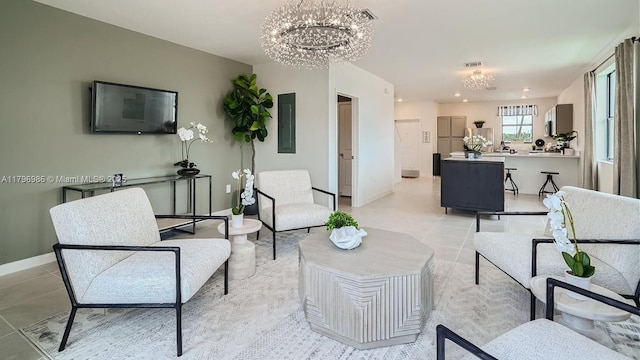 living room featuring a notable chandelier, baseboards, light tile patterned floors, and visible vents