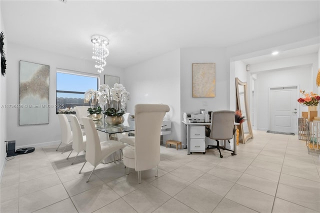 dining area with baseboards, tile patterned flooring, and an inviting chandelier