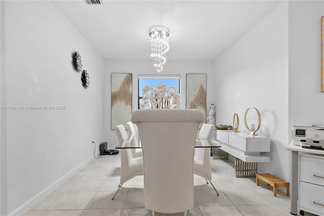 dining area featuring light tile patterned floors, visible vents, baseboards, and a notable chandelier