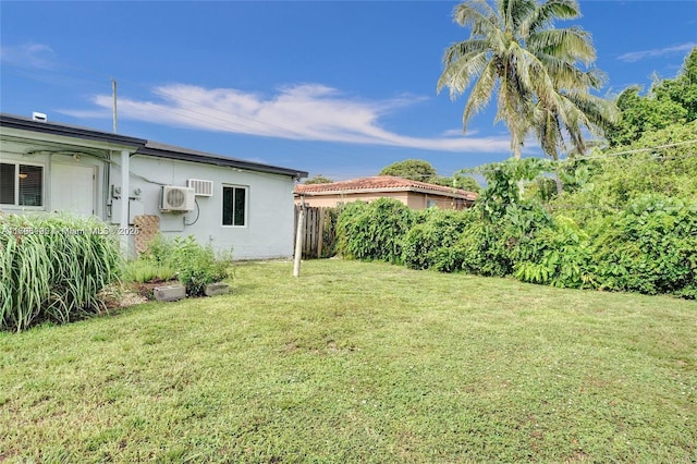 view of yard with fence and ac unit