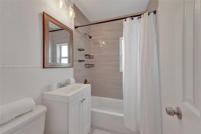 full bath with vanity, shower / tub combo with curtain, and toilet