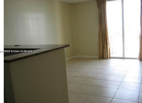 215 SW 42nd Ave Unit 905, Miami, FL 33134 - empty room featuring light tile patterned floors and baseboards