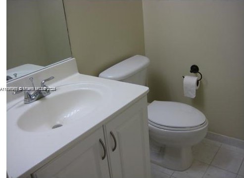 215 SW 42nd Ave Unit 905, Miami, FL 33134 - bathroom with toilet, vanity, tile patterned flooring, and baseboards