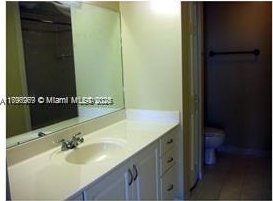215 SW 42nd Ave Unit 905, Miami, FL 33134 - bathroom featuring toilet, vanity, and tile patterned flooring