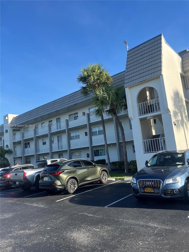 8280 Sunrise Lakes Blvd Unit 301, Sunrise, FL 33322 - view of building exterior with uncovered parking