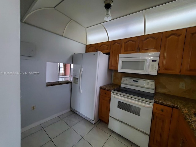 8280 Sunrise Lakes Blvd Unit 301, Sunrise, FL 33322 - kitchen featuring light tile patterned floors, brown cabinetry, and white appliances