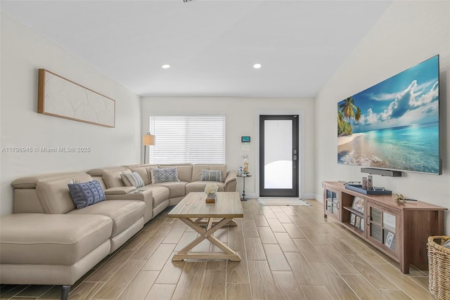 living area with baseboards, wood tiled floor, and recessed lighting