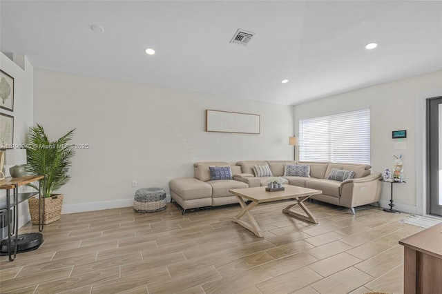 living area featuring visible vents, baseboards, wood finish floors, and recessed lighting