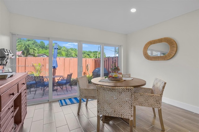 dining area with wood finish floors, baseboards, and recessed lighting