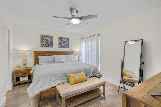 bedroom with baseboards, a ceiling fan, and wood finish floors