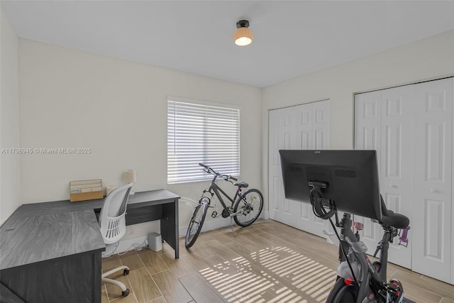 home office with wood finish floors and baseboards