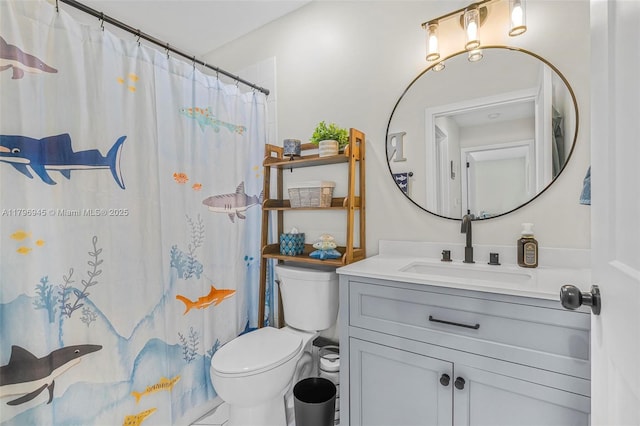 bathroom with curtained shower, vanity, and toilet
