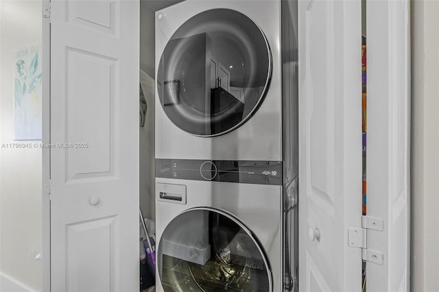 clothes washing area featuring laundry area and stacked washer and dryer
