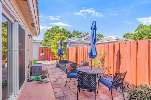 view of patio / terrace featuring outdoor dining area and fence
