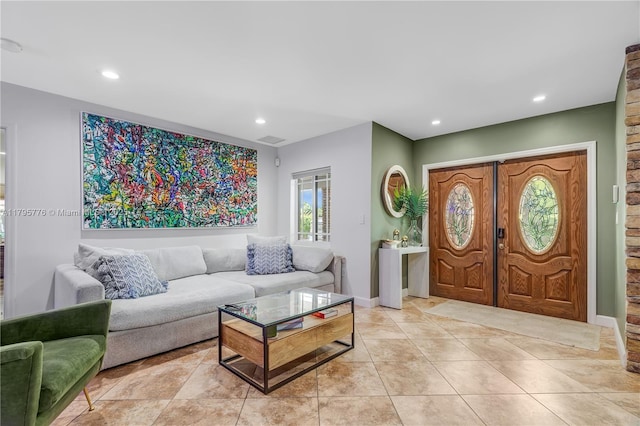living area featuring visible vents and recessed lighting