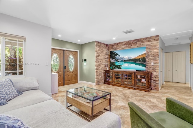 living room with light tile patterned floors, recessed lighting, baseboards, and visible vents