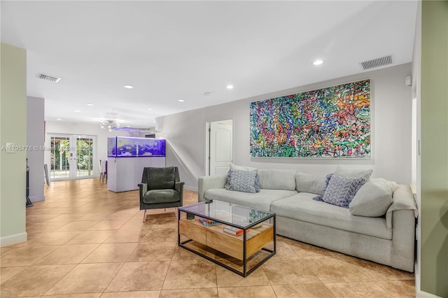 living room with light tile patterned floors, visible vents, and french doors