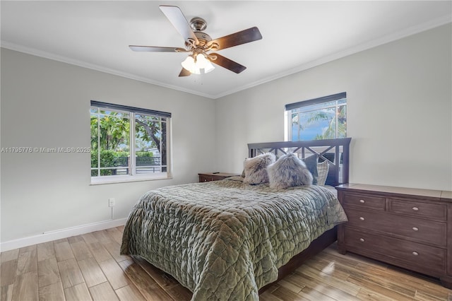 bedroom featuring crown molding, baseboards, a ceiling fan, and light wood-style floors