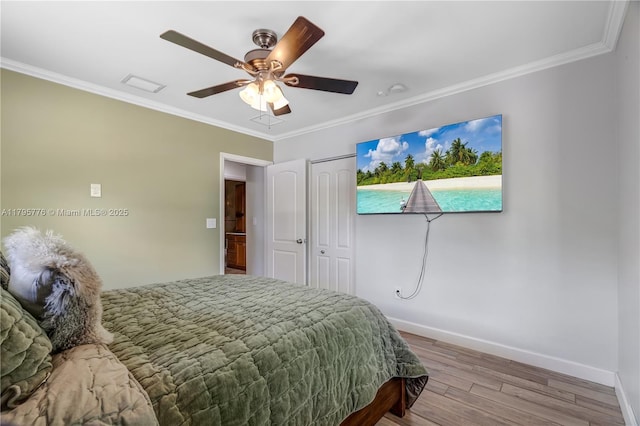 bedroom with crown molding, baseboards, ceiling fan, and wood finished floors