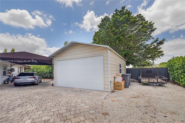 detached garage featuring fence