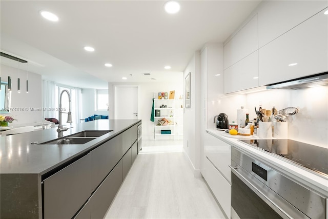 665 NE 25th St Unit 2301, Miami, FL 33137 - kitchen featuring modern cabinets, oven, light wood finished floors, white cabinets, and recessed lighting