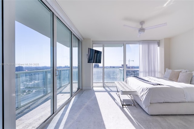 bedroom with concrete floors, floor to ceiling windows, and access to exterior
