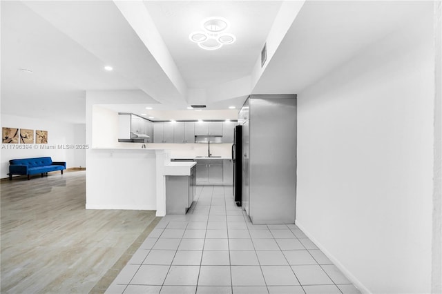 406 Saint Andrews Rd Unit 53, Hollywood, FL 33021 - kitchen with a peninsula, freestanding refrigerator, open floor plan, light countertops, and baseboards