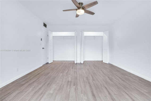 406 Saint Andrews Rd Unit 53, Hollywood, FL 33021 - unfurnished bedroom with baseboards, multiple closets, visible vents, and wood finished floors