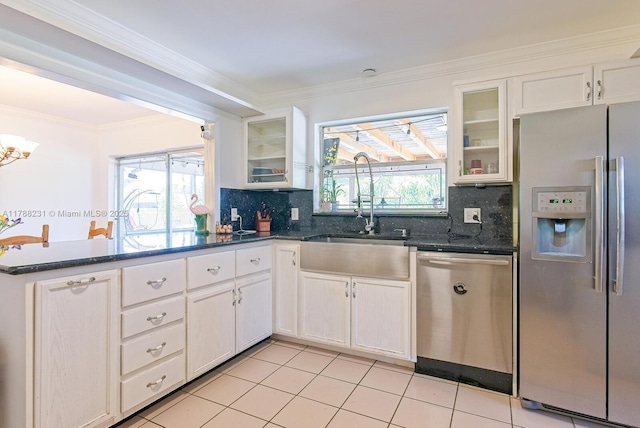 kitchen featuring a sink, ornamental molding, tasteful backsplash, and appliances with stainless steel finishes