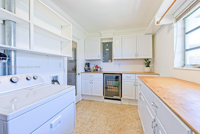 kitchen with open shelves, beverage cooler, white cabinets, and washer / clothes dryer