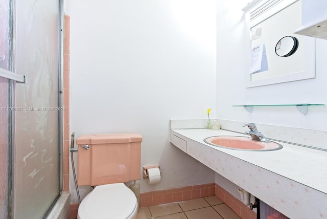 full bathroom with toilet, tile patterned floors, vanity, and a stall shower
