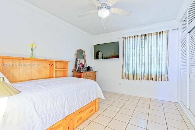 tiled bedroom featuring crown molding, baseboards, and a ceiling fan