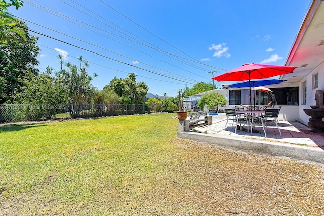 view of yard with fence and a patio