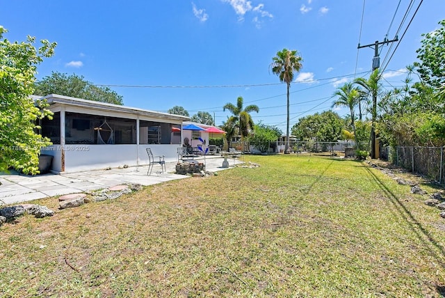 view of yard featuring a fenced backyard, a sunroom, and a patio