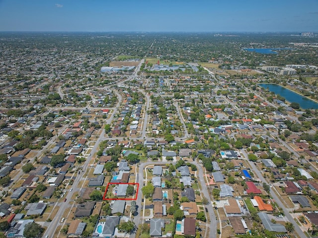 drone / aerial view with a water view and a residential view