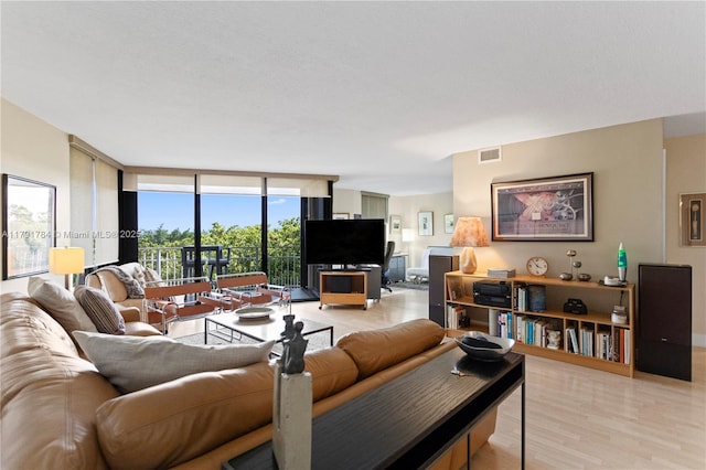 2000 Towerside Ter Unit 710, Miami, FL 33138 - living area featuring a wall of windows and light wood-style floors