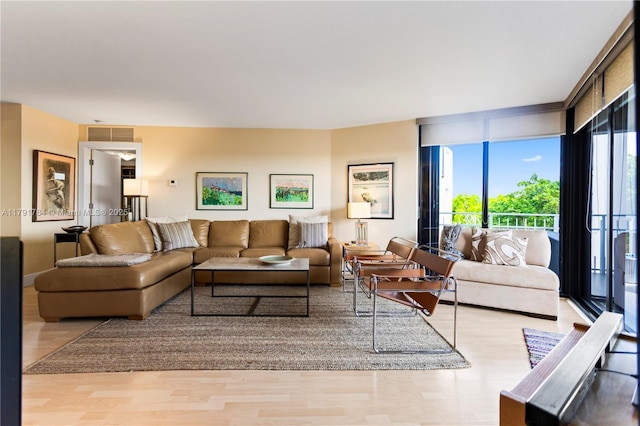 living room with visible vents and wood finished floors