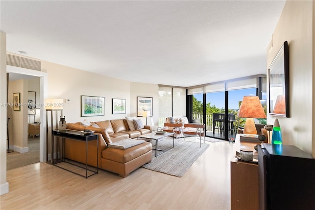 2000 Towerside Ter Unit 710, Miami, FL 33138 - living area featuring floor to ceiling windows and light wood finished floors