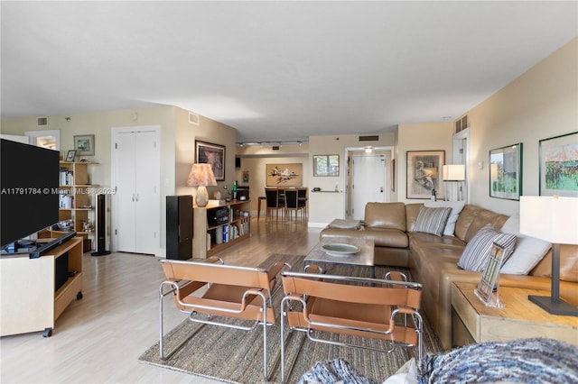 living room with visible vents and wood finished floors